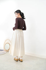 Ivory in a cut skirt with waist strap
