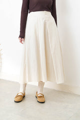 Ivory in a cut skirt with waist strap
