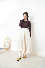 Ivory in a cut skirt with waist strap