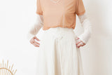 Ivory in a cut skirt with waist strap