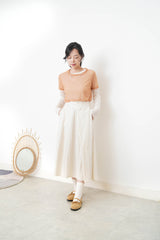 Ivory in a cut skirt with waist strap