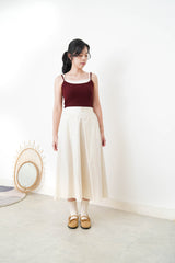 Ivory in a cut skirt with waist strap