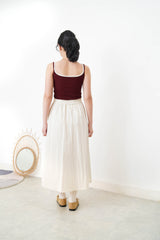 Ivory in a cut skirt with waist strap