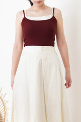 Ivory in a cut skirt with waist strap
