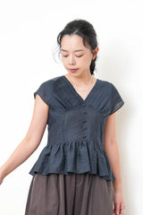 Navy V neck blouse in peplum hem
