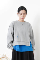 Grey pullover in asymmetrical 3D cut