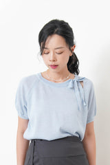 Blue knit top w/ ribbon collar details