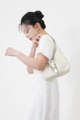 Ivory leather shoulder bag w/ belt details