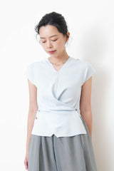 Baby blue vest in overlaping waist details