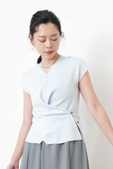 Baby blue vest in overlaping waist details
