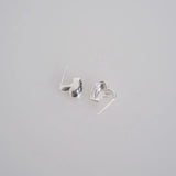 Silver heart shape earrings in cross section