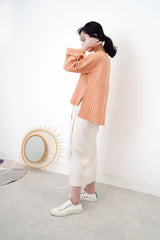 Peach knit sweater in stepped hem