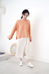 Peach knit sweater in stepped hem