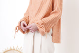 Peach knit sweater in stepped hem
