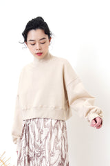 Nude crop cut pullover in stand collar