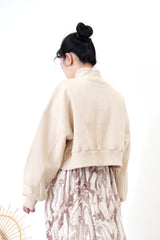 Nude crop cut pullover in stand collar