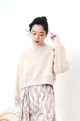 Nude crop cut pullover in stand collar