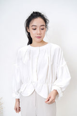 White linen blouse in peplum hem