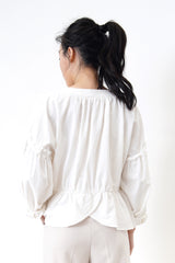 White linen blouse in peplum hem