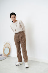 Nude satin blouse in asymmetrical cutting