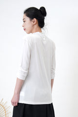 White blouse in drape layering detail