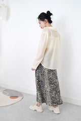 Pastel yellow sheer shirt in texture detail