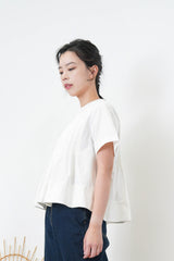 White pleats top in peplum hem