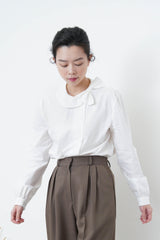 White shirt in ribbon detail collar