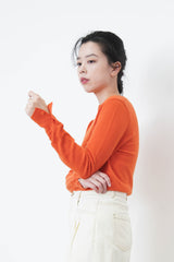 Orange wool top in buttons sleeves