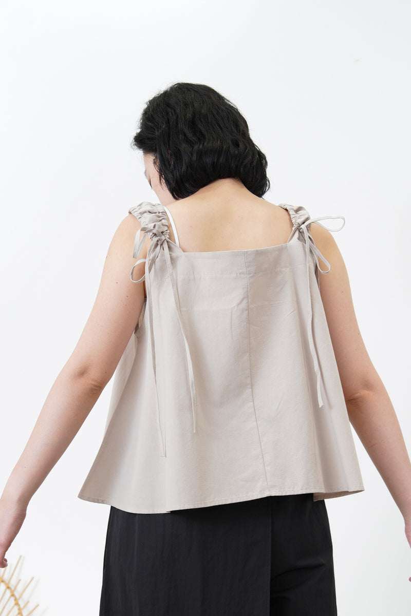 A cut vest in adjustable strings straps