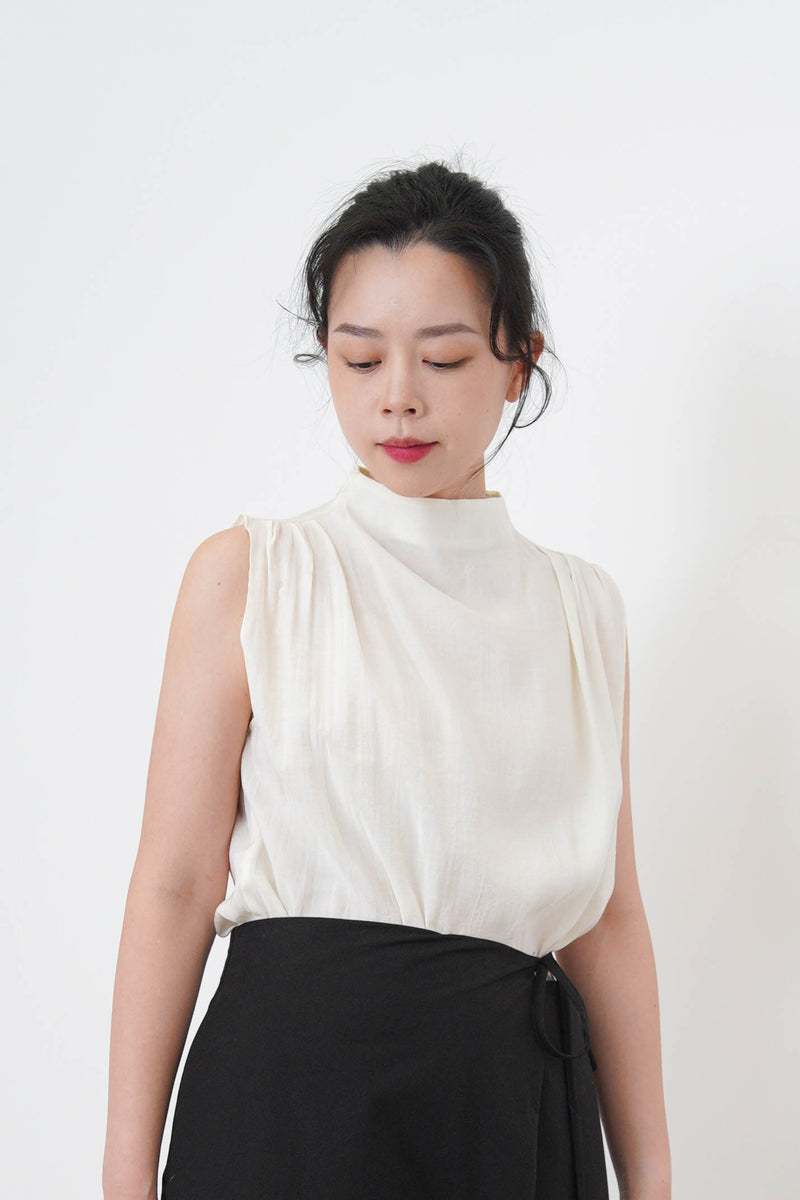 Ivory high neck blouse in pleats shoulders
