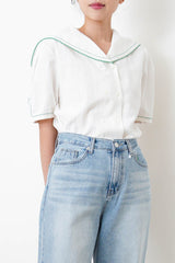 White linen sailor top in green stitches