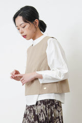 Beige vest w/ badge