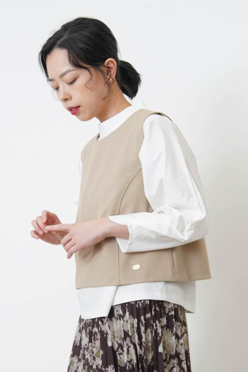 Beige vest w/ badge