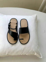Black asymmetrical shape sandals