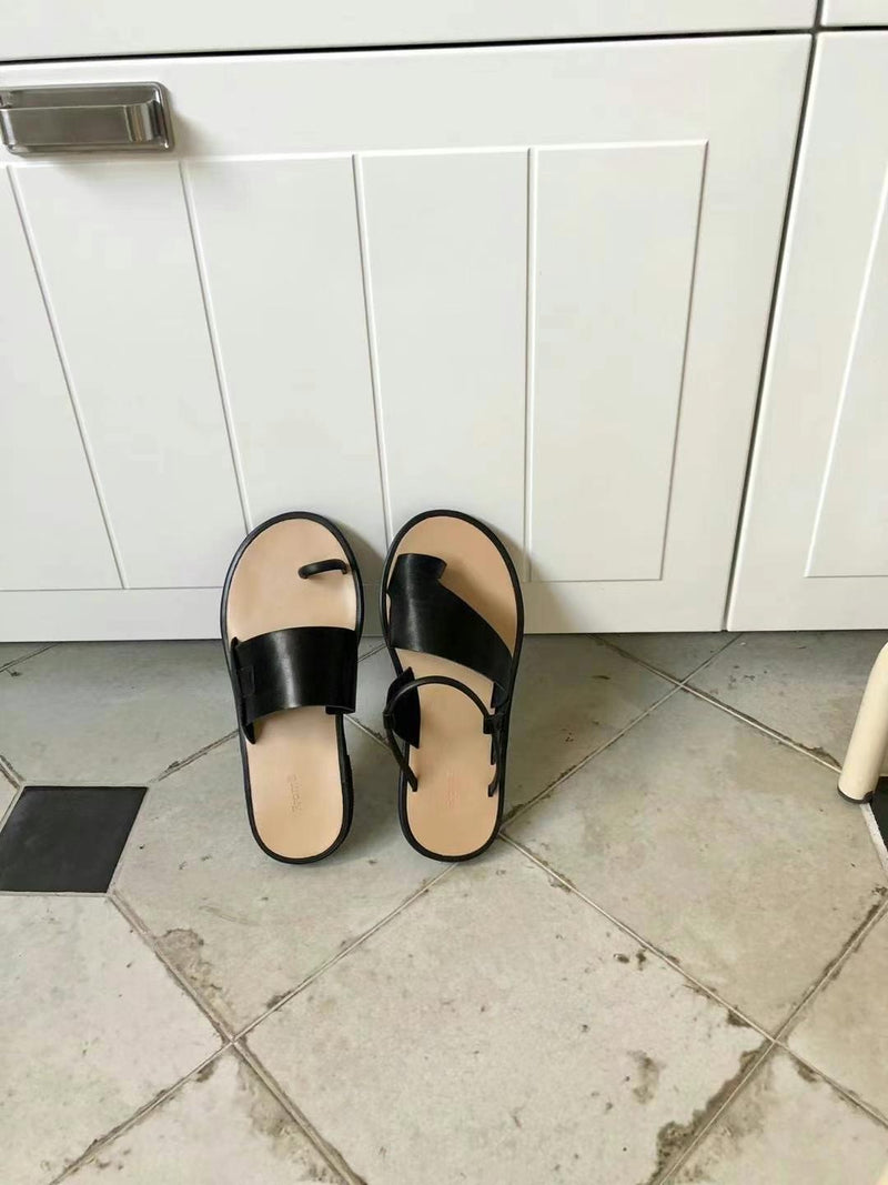 Black asymmetrical shape sandals