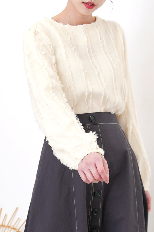 Ivory blouse in fringe trimmed details