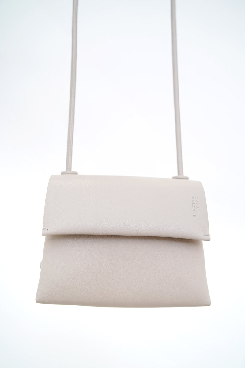 Grey leather cross body bag in thin strap