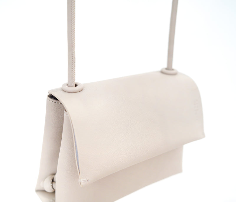Grey leather cross body bag in thin strap