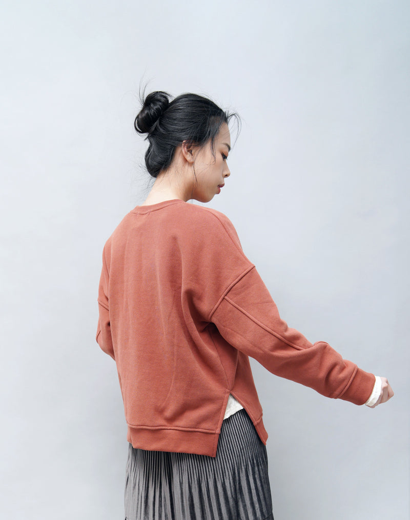 Brick red pullover in side vents