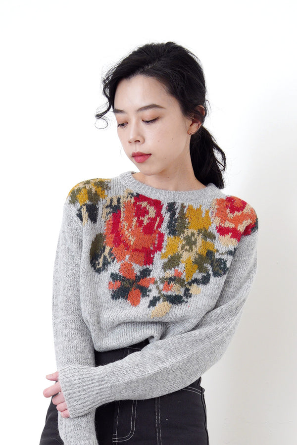 Grey knit sweater in floral cross stitch