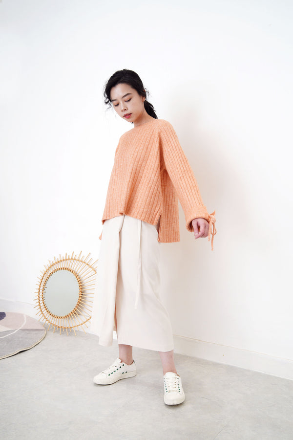 Peach knit sweater in stepped hem