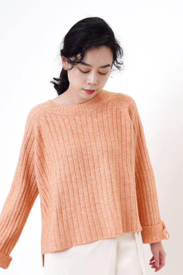 Peach knit sweater in stepped hem