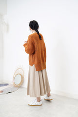 Orange tone sweater in stepped hem