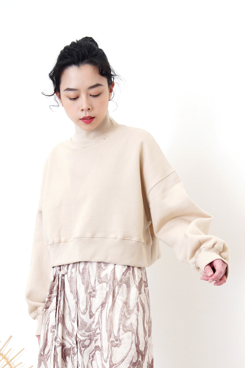 Nude crop cut pullover in stand collar