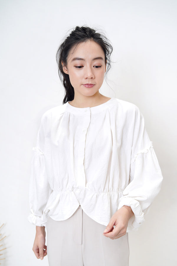 White linen blouse in peplum hem
