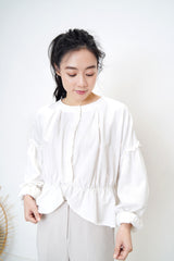White linen blouse in peplum hem