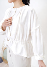 White linen blouse in peplum hem