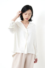 Ivory loose cut blouse in stepped hem