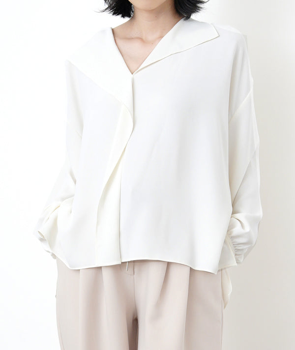 Ivory loose cut blouse in stepped hem